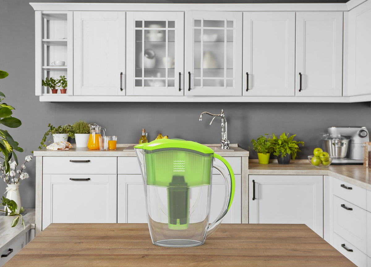 Lime green Drinkpod alkaline water filter pitcher in a kitchen setting
